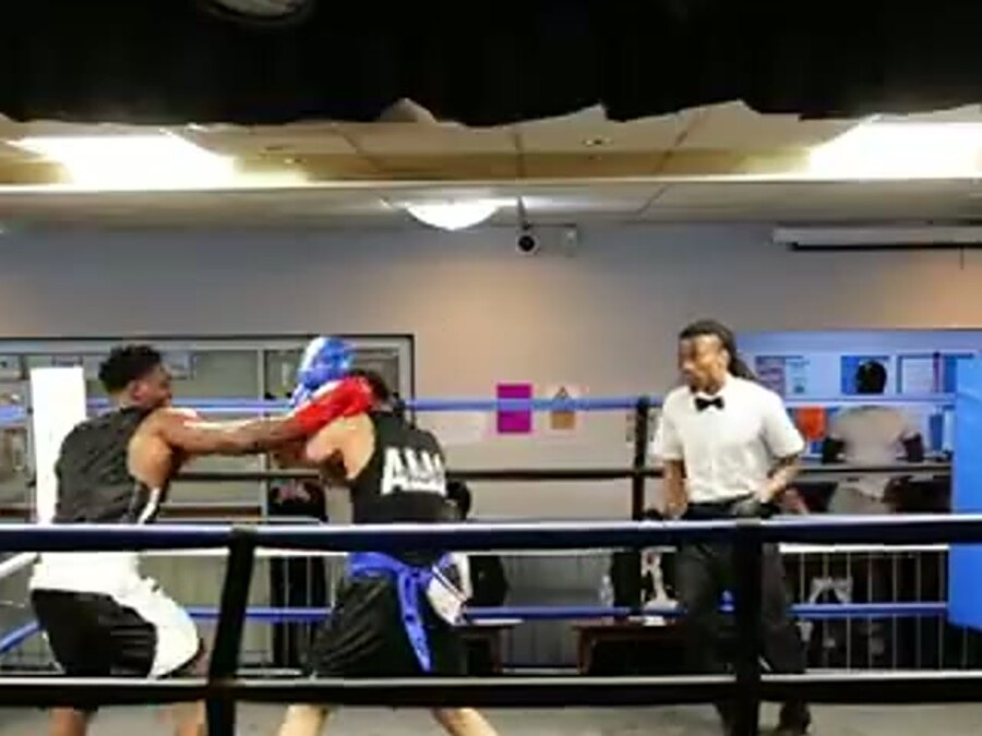Amateur boxer throwing a straight punch in the ring